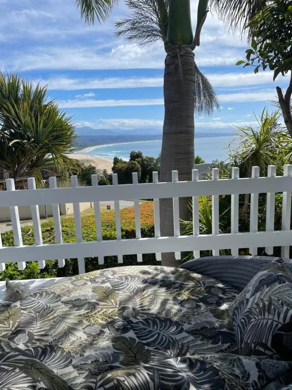 Scenic coastal lagoon and beach view from property balcony with palm tree
