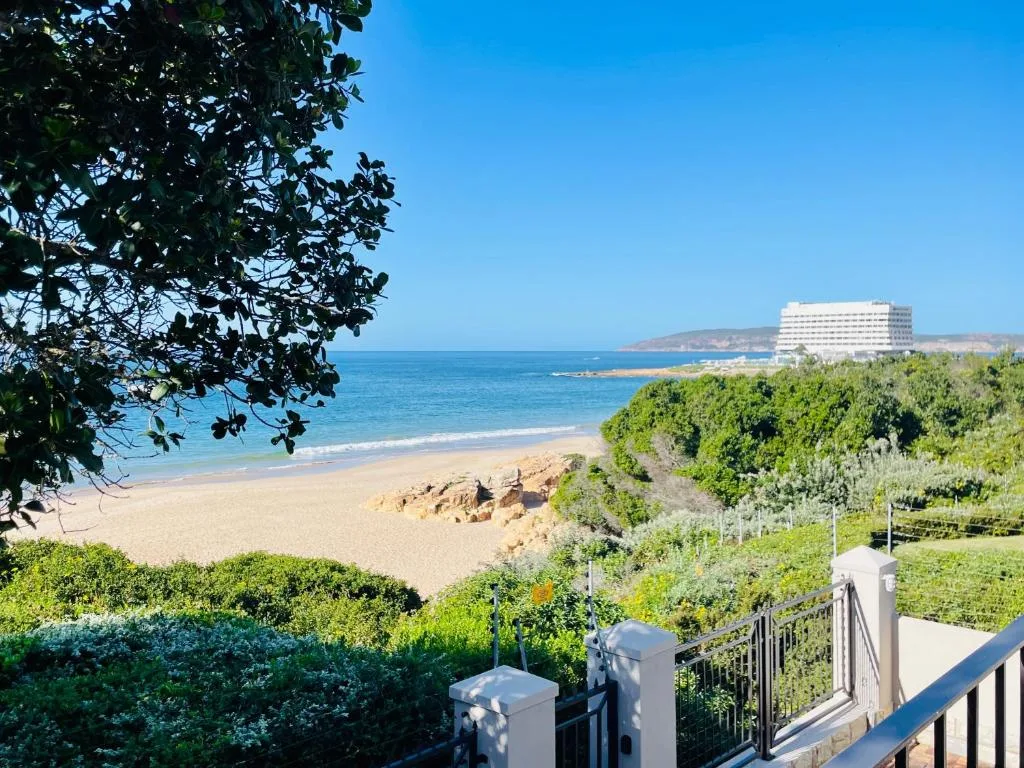 Pristine beach and ocean vista with coastal vegetation and headland