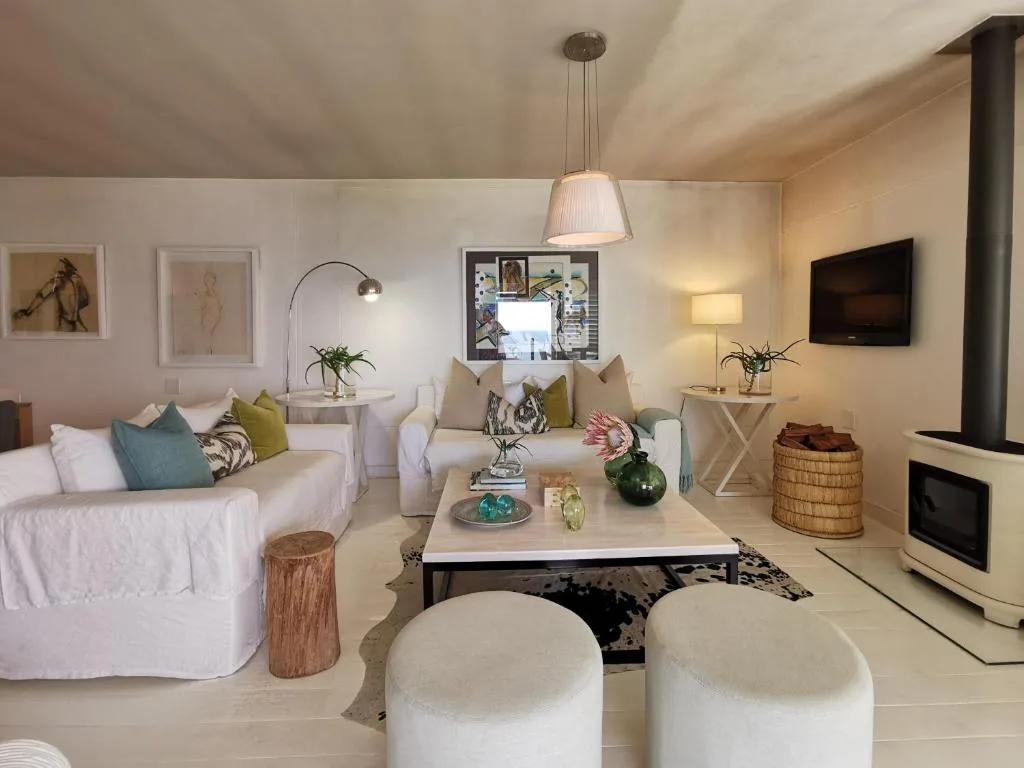 Spacious lounge with comfortable sofas, fireplace, and entertainment area
