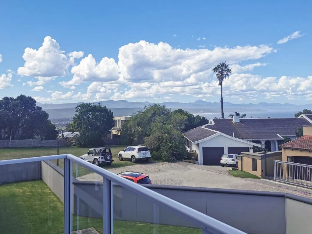 Mountain and lagoon vista from property deck with residential surroundings