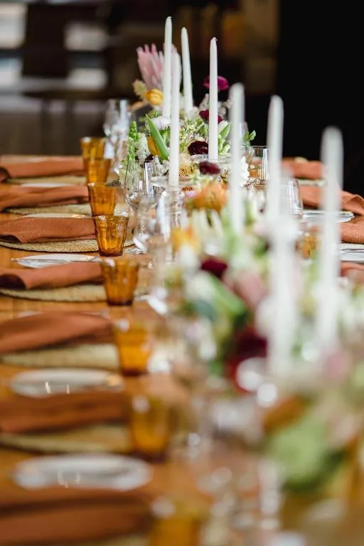 Elegant dining table set with floral centerpieces and white candles