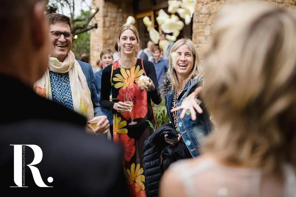 Guests socializing and celebrating on the villa's outdoor courtyard area