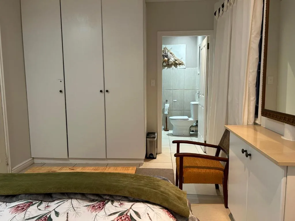 Bedroom with built-in wardrobes and ensuite bathroom doorway visible