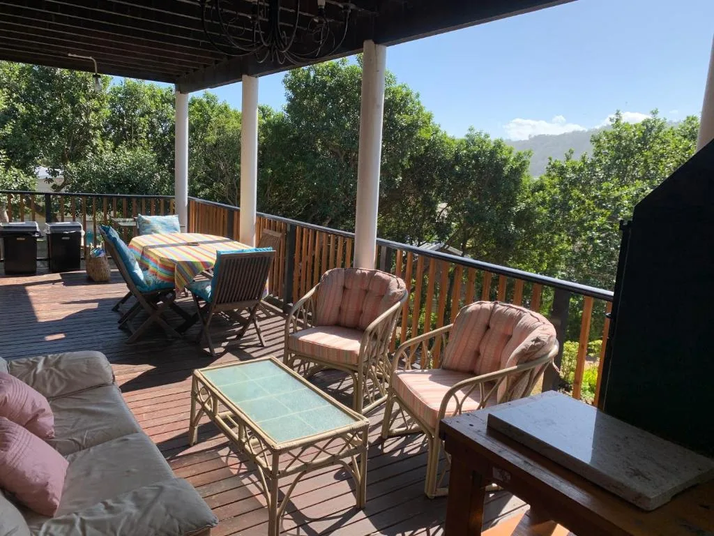Spacious covered deck with comfortable seating and mountain views