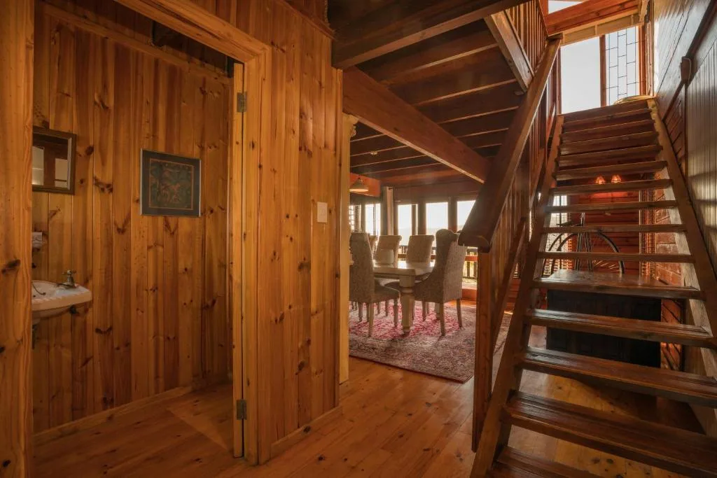 Rustic wooden interior with staircase and open-plan living space layout
