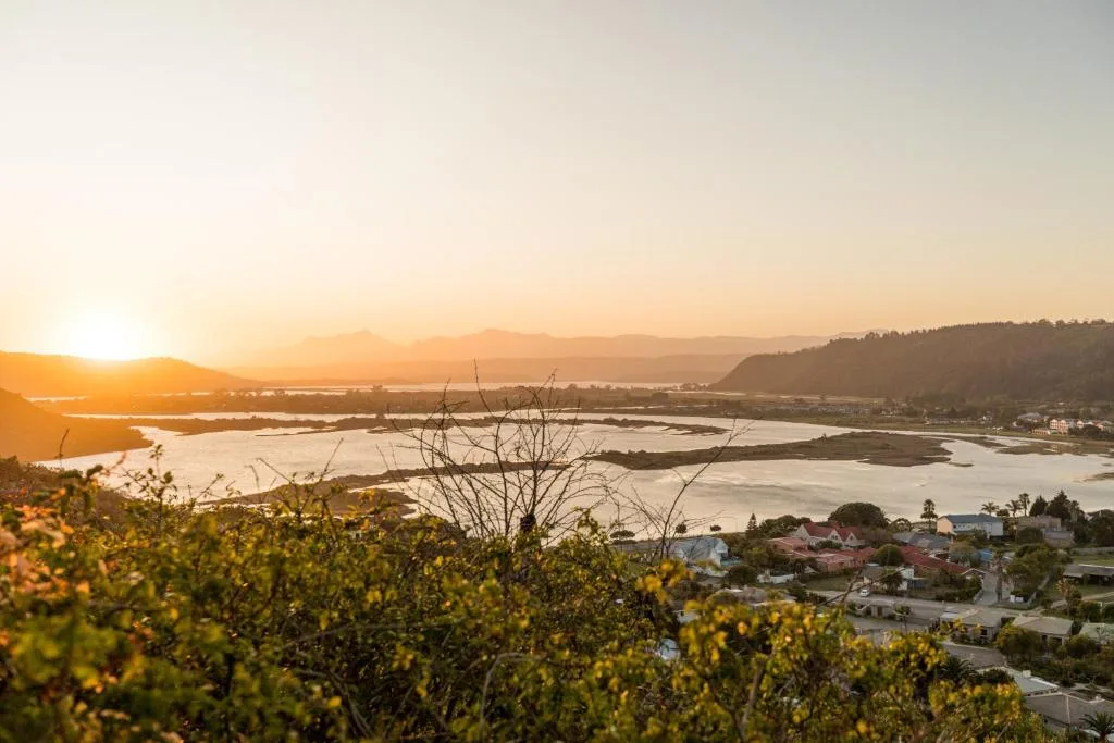 Sunset over Sedgefield lagoon with mountains and coastal town visible