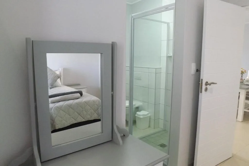 Modern bathroom with walk-in shower enclosure and white tile walls