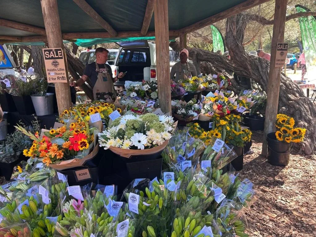 Colorful flower market stall with sunflowers and blooms displayed