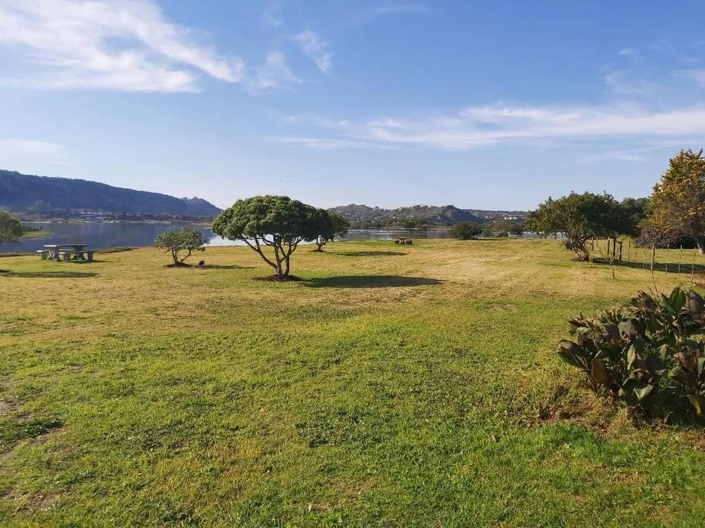 Scenic lagoon and mountain views across sprawling green gardens