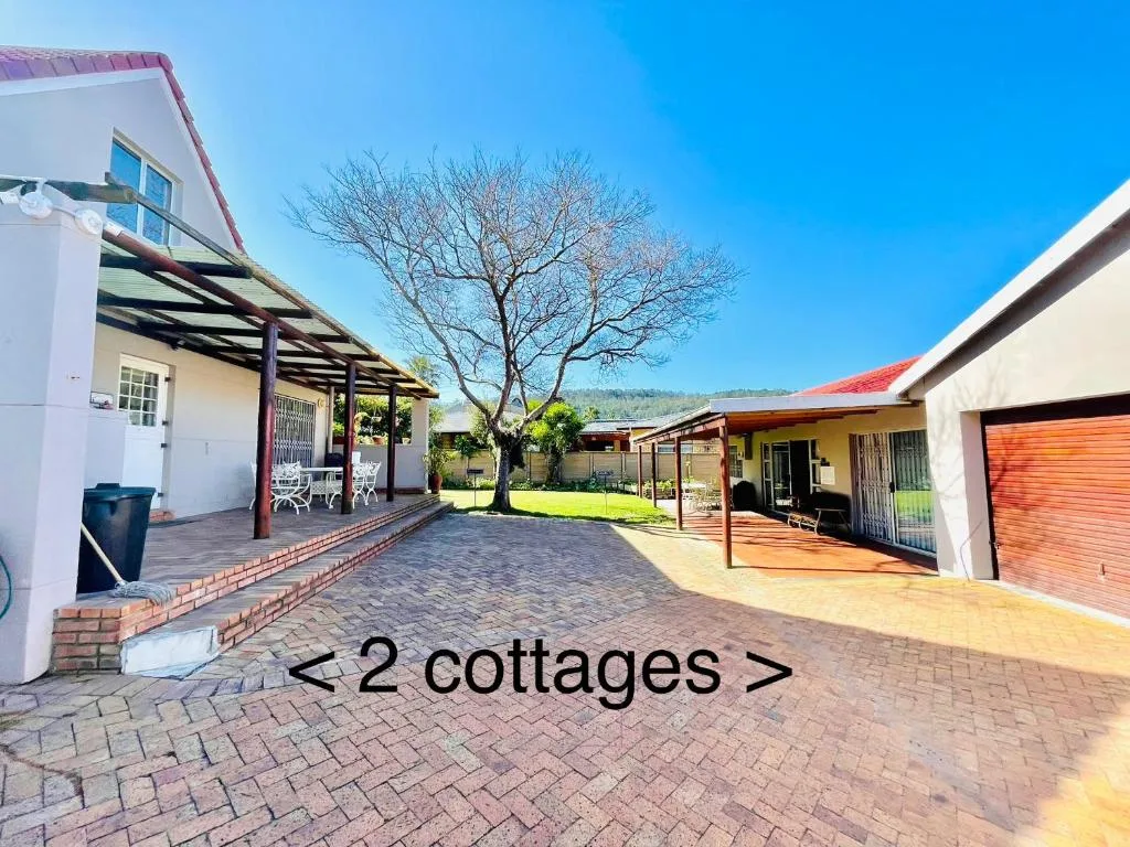 Two self-catering cottages with paved courtyard and pergolas, set in a garden