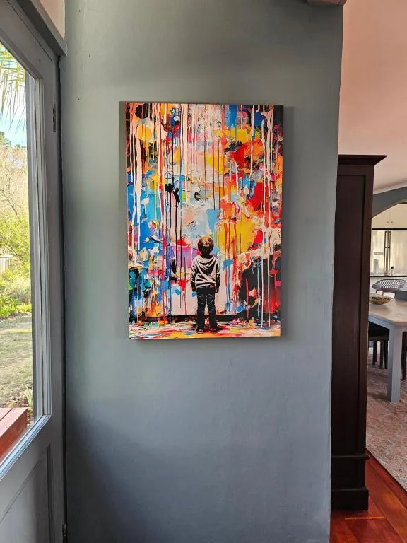 Colorful contemporary artwork featuring child figure on vibrant painted wall