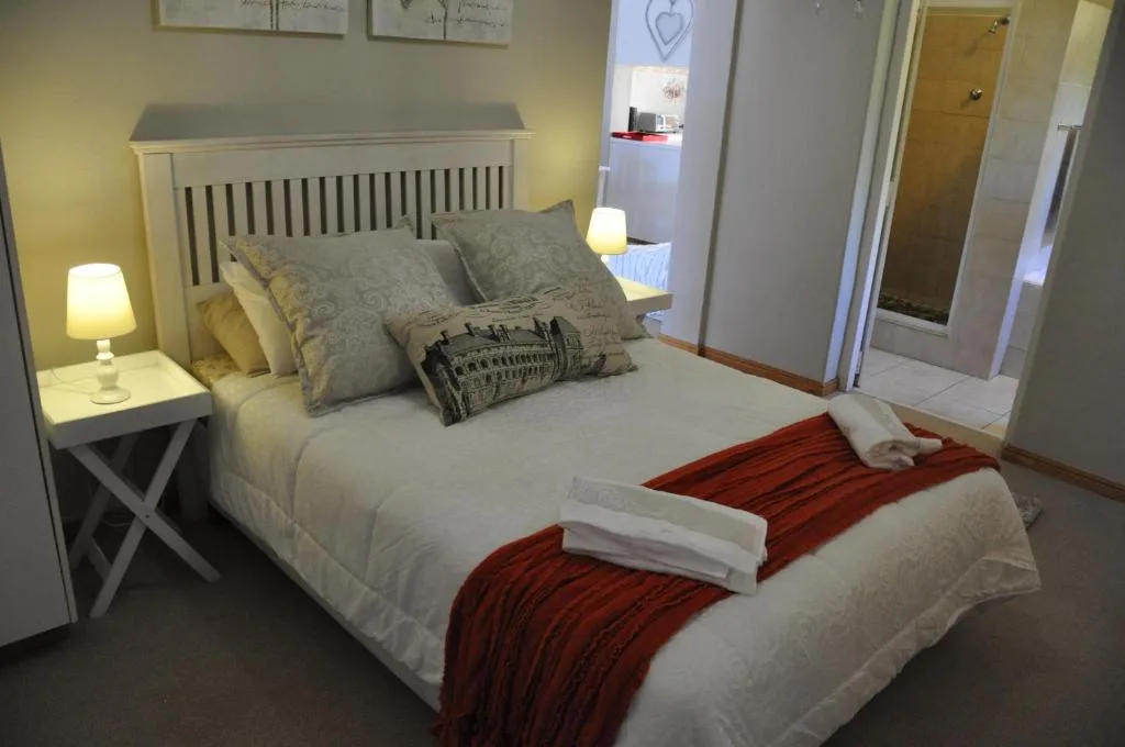 Bright bedroom with queen bed, fresh linens, and welcoming decor