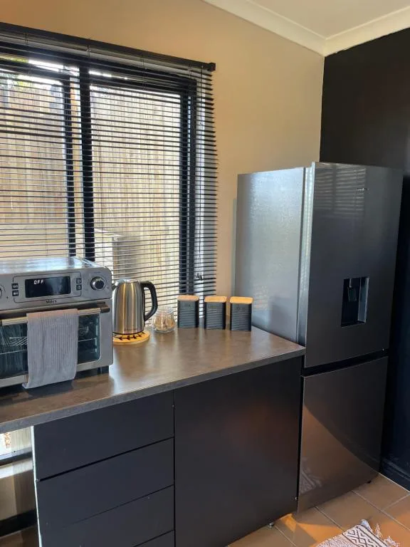 Modern kitchen with stainless steel appliances and black cabinetry island
