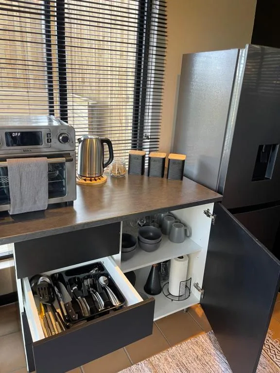 Modern kitchen with stainless steel appliances and organized storage drawers
