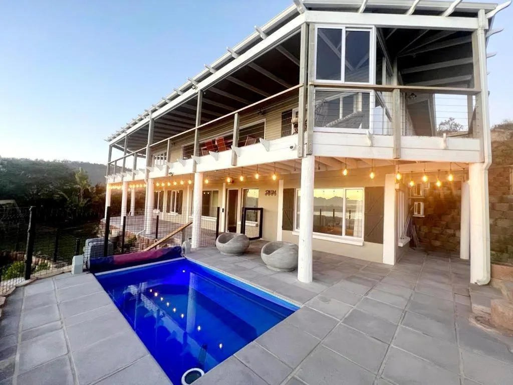 Modern outdoor entertaining area with pool and covered patio space