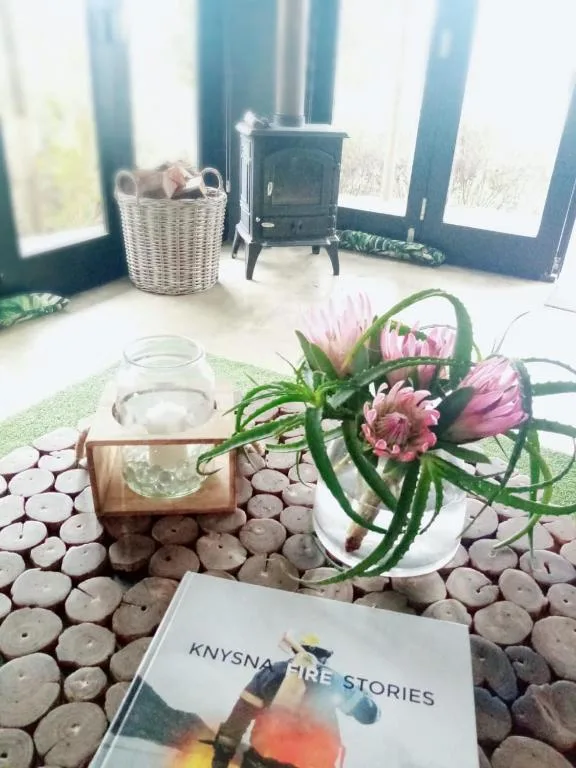 Cozy indoor decor with fireplace, fresh flowers, candles and magazine