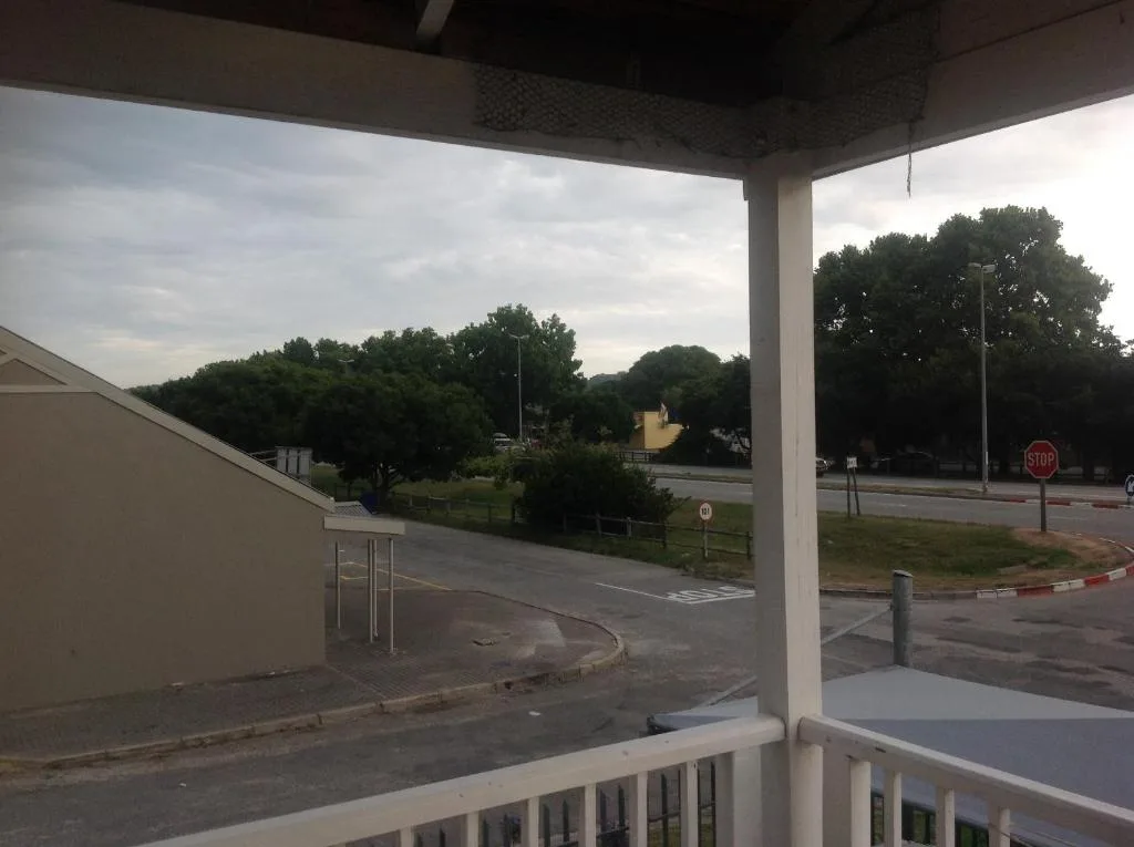 Leafy trees and suburban neighborhood landscape from covered deck