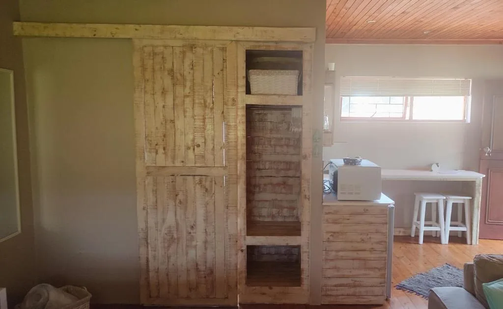 Bedroom with wooden sliding door and built-in shelving unit
