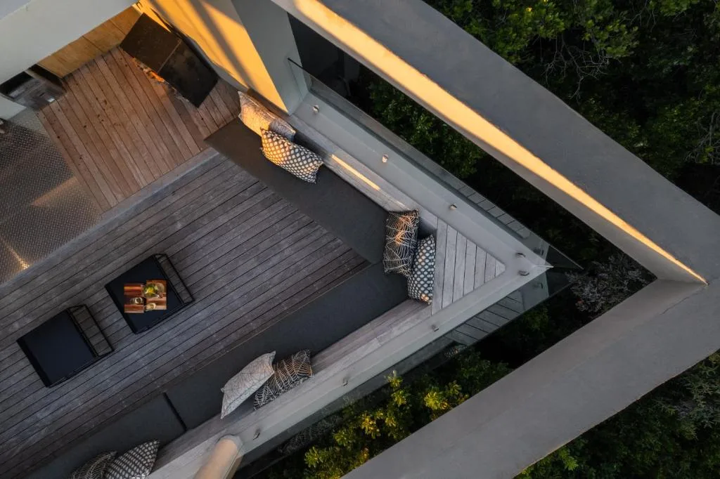 Modern wooden deck with comfortable seating and golden hour sunlight