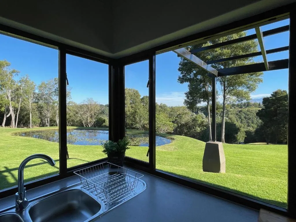 Expansive garden and water features visible through large windows from indoors