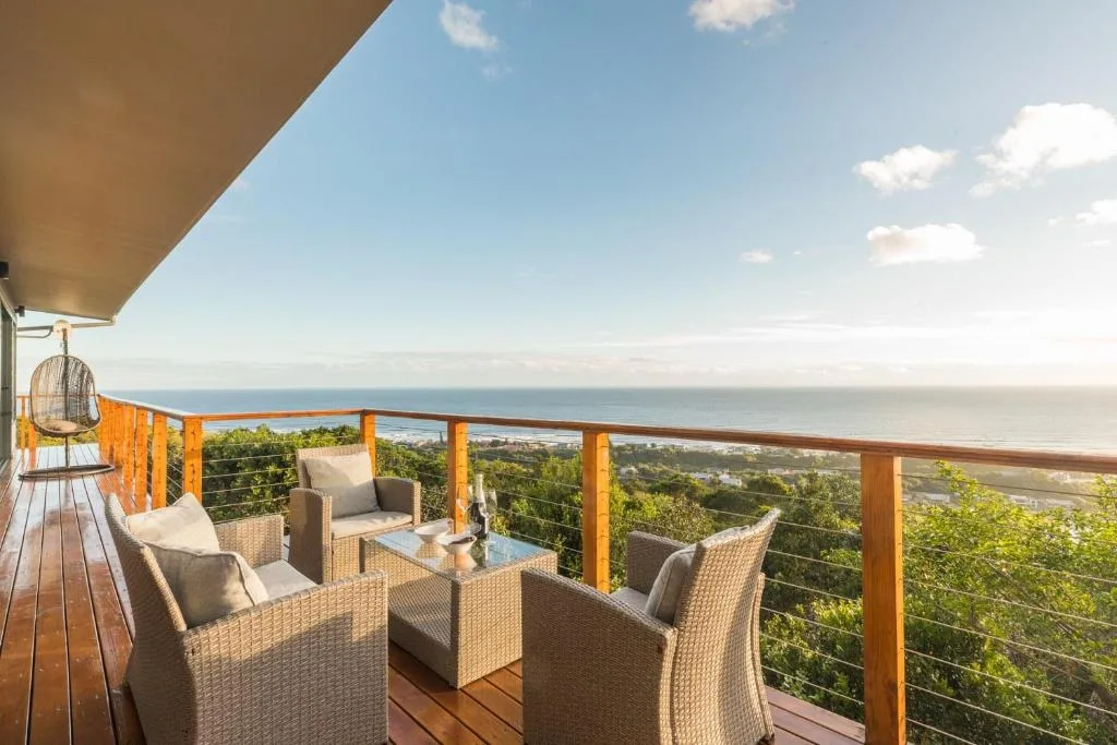 Outdoor deck with rattan seating and ocean views along the Garden Route
