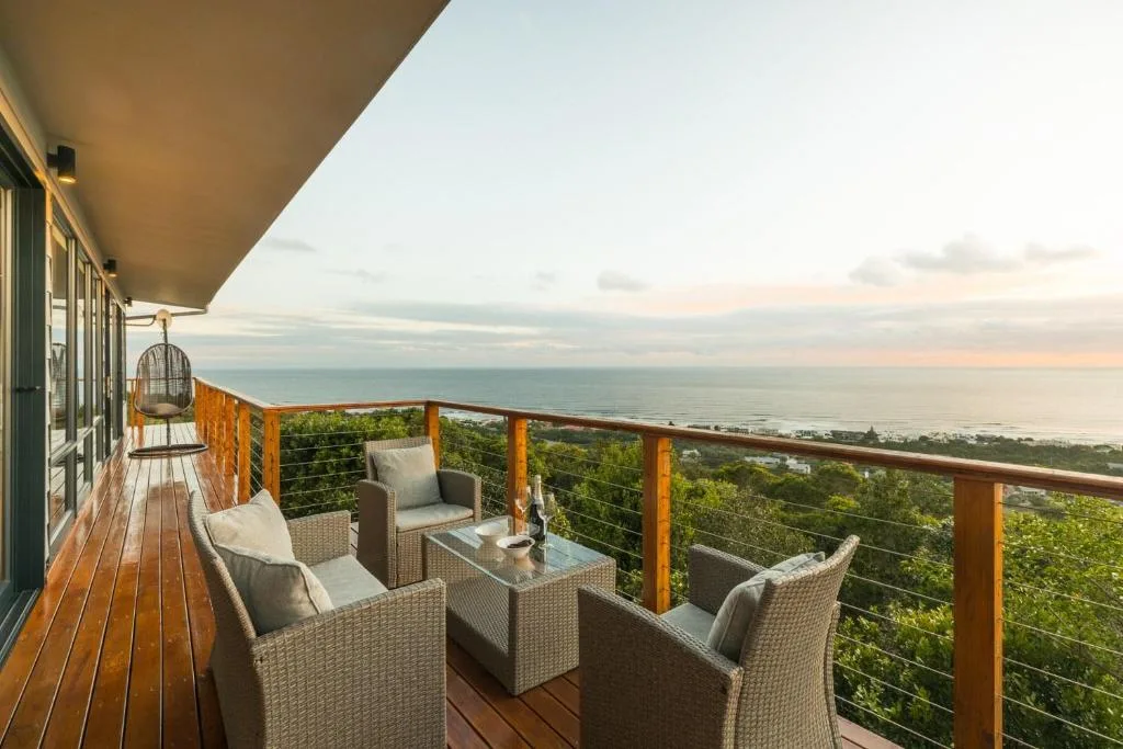 Wooden deck with comfortable seating overlooking ocean and coastal views