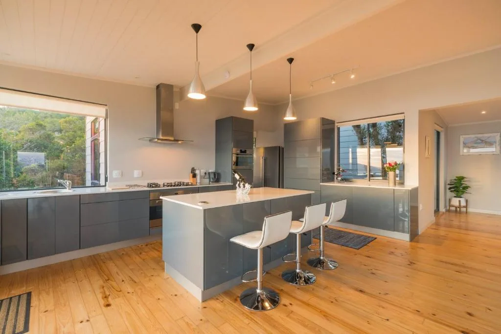 Modern kitchen with dark cabinetry, island seating, and pendant lighting
