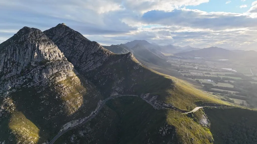 Dramatic mountain peaks and verdant valley landscape view from property