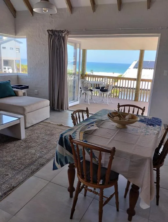 Ocean and beach view through large windows from dining area