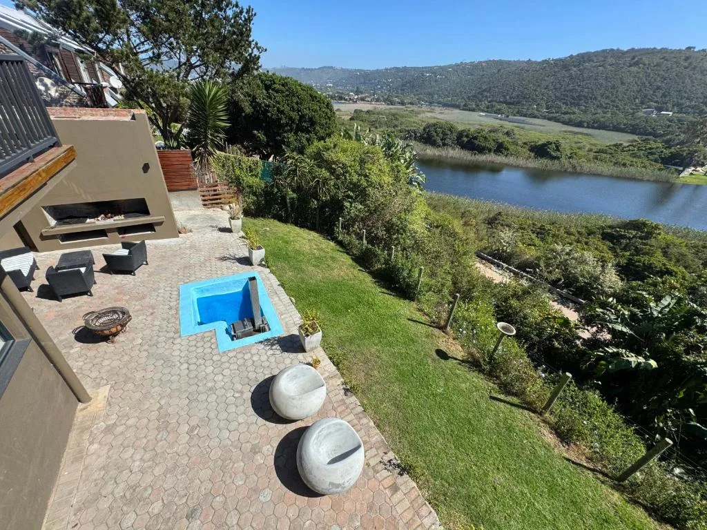 Lagoon and forested hillside vista from elevated property deck