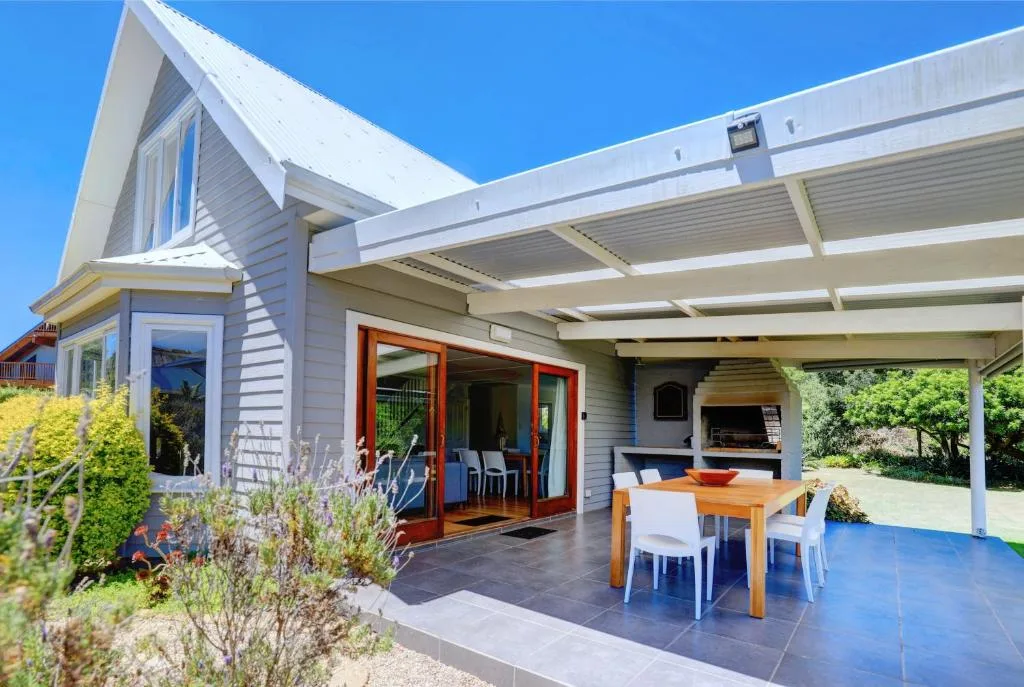 Spacious covered patio with dining table and outdoor seating area