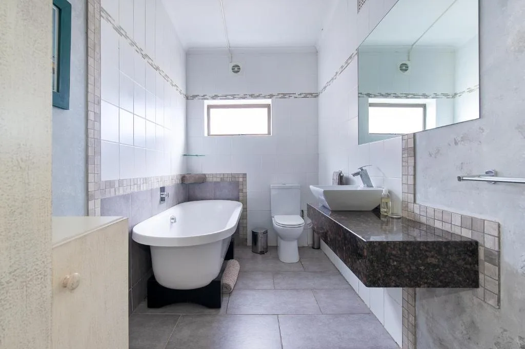 Modern bathroom with freestanding tub, vanity sink, and toilet fixtures