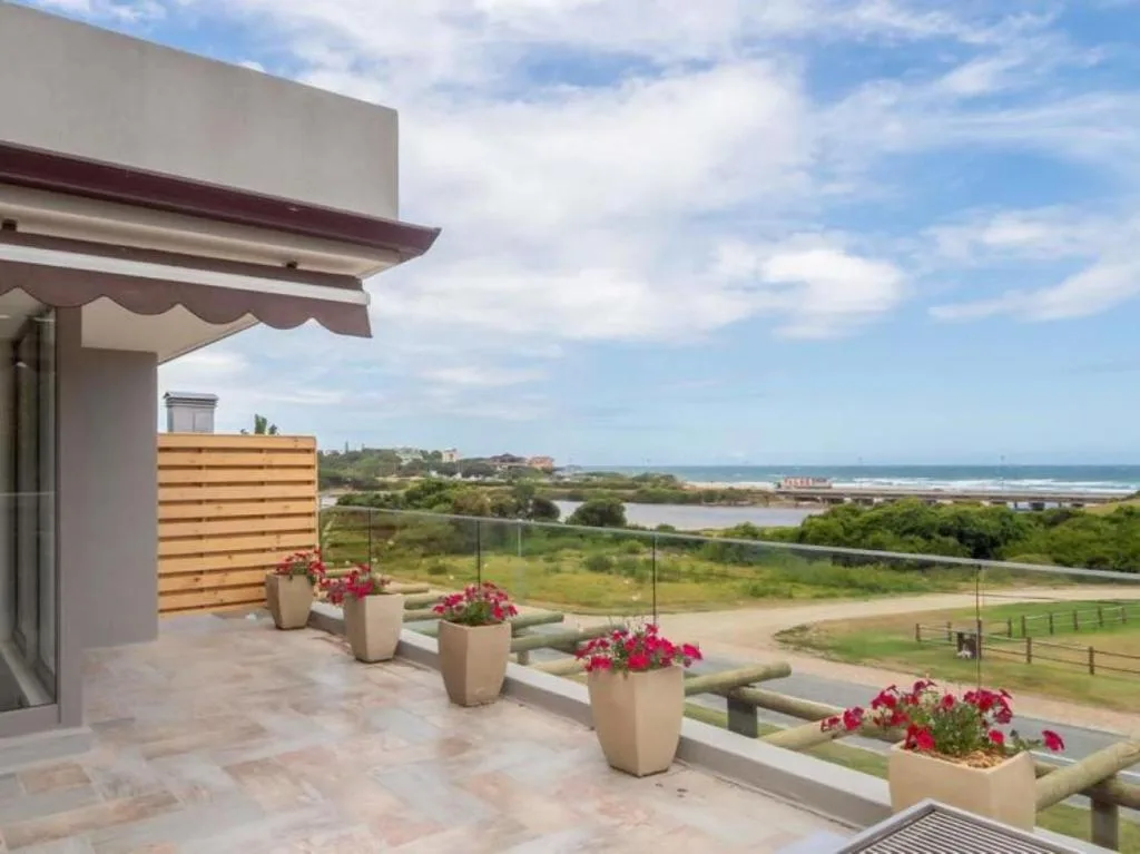 Scenic lagoon and ocean views from elevated deck with flowering planters