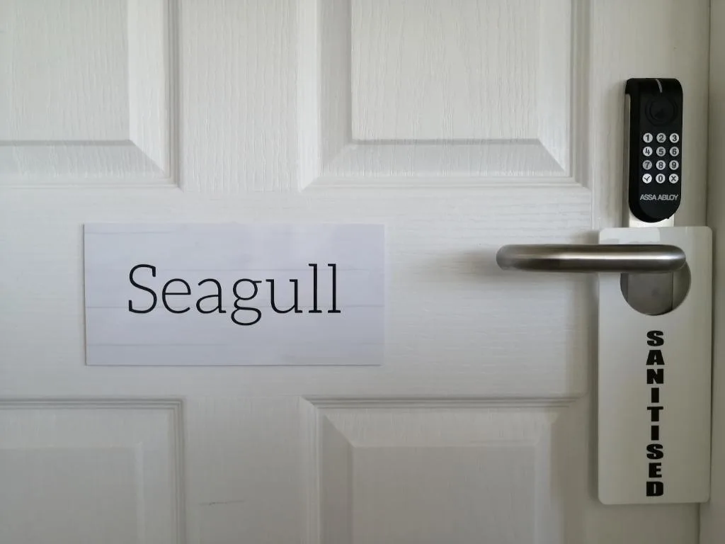 White door with Seagull nameplate and digital keypad lock