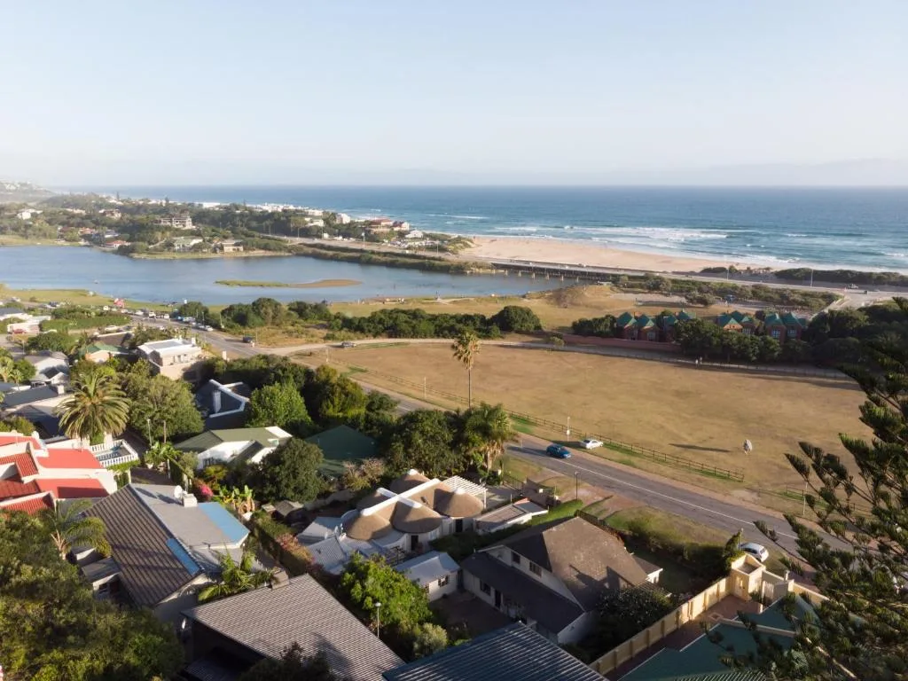 Aerial view of Wilderness lagoon, beach, and surrounding properties with ocean