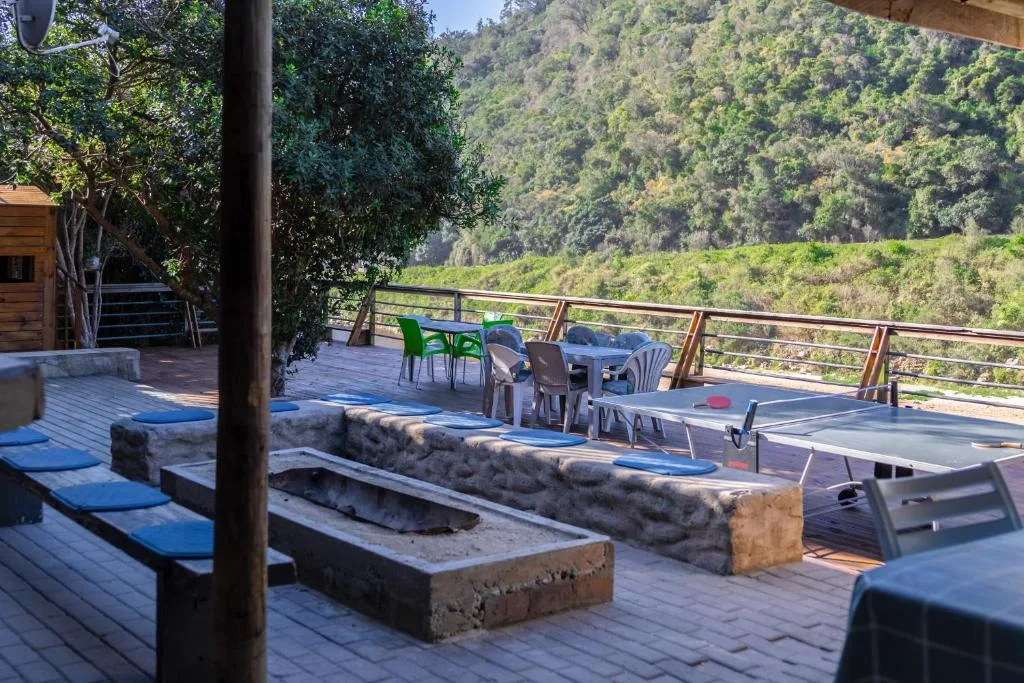Spacious wooden deck with firepit, seating, and mountain views