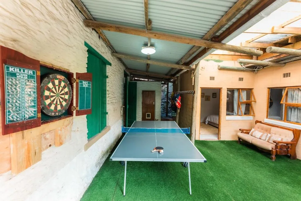 Covered recreation area with ping pong table, dartboard, and games