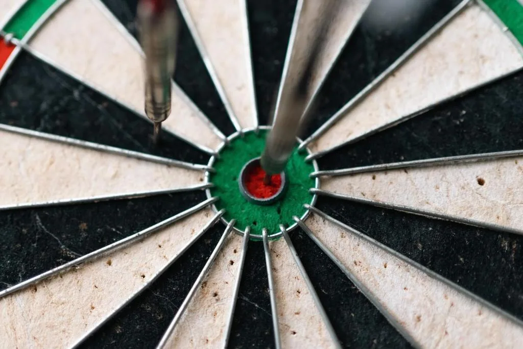 Close-up of a dartboard with darts in the bullseye center