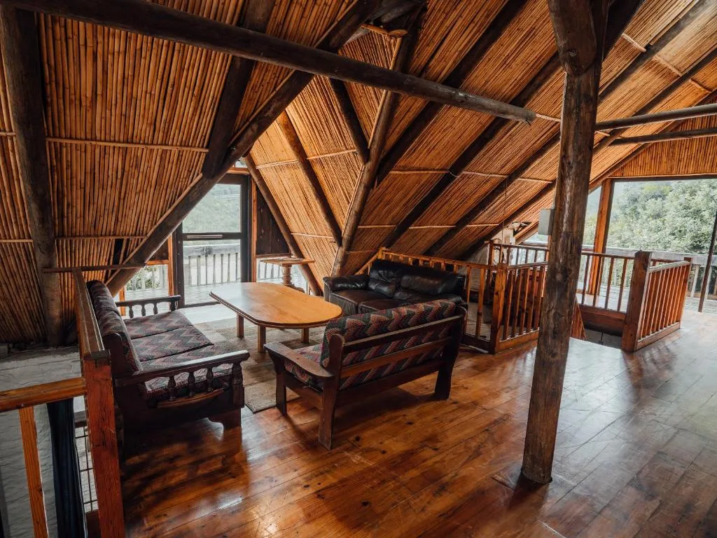 Spacious wooden loft lounge with leather seating and mountain views