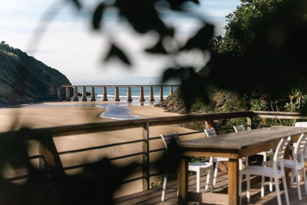 Scenic coastal view of historic pier and sandy beach from property deck