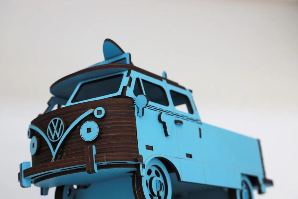 Vintage blue Volkswagen van toy sculpture with surfboard decoration