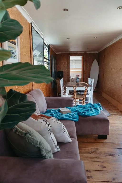 Spacious lounge with plush seating and wooden beams throughout