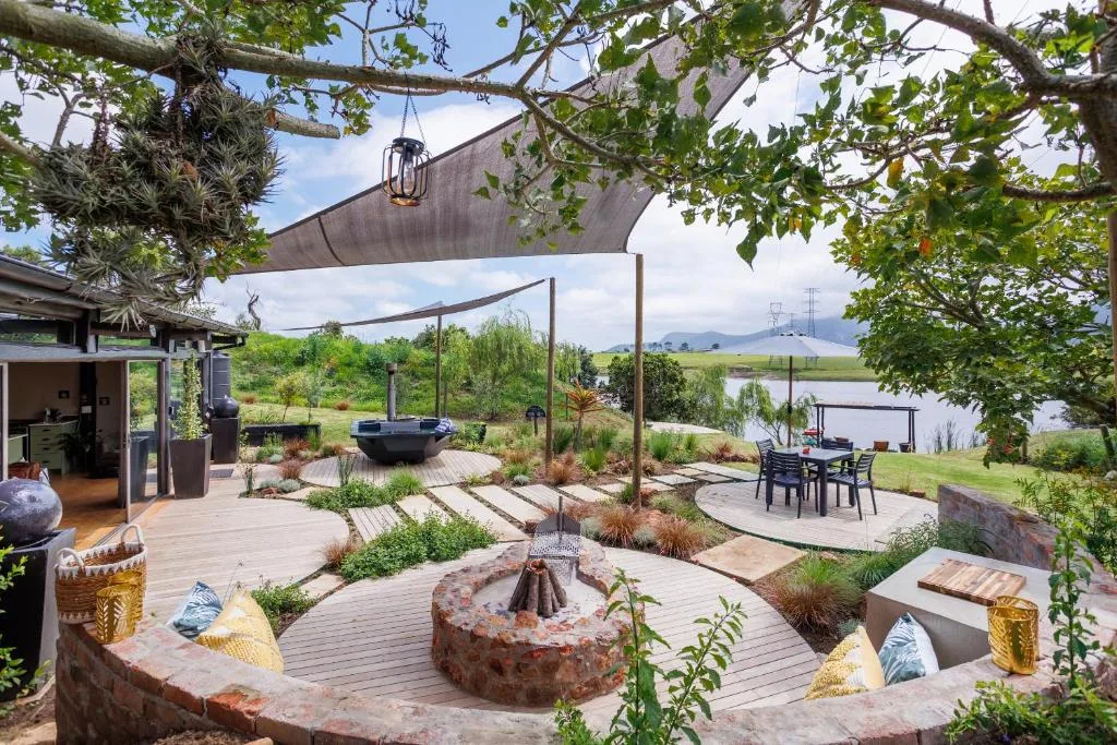 Spacious outdoor deck with fire pit, shade sails, and mountain views