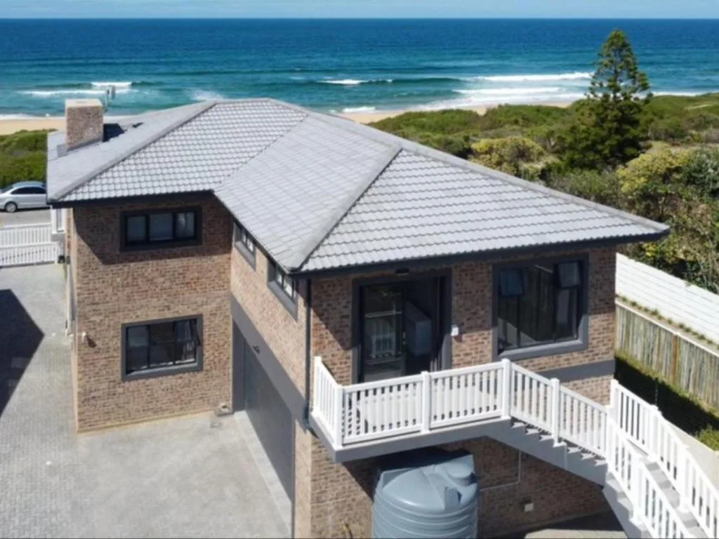 Modern brick home with ocean view deck overlooking Wilderness beach and sea