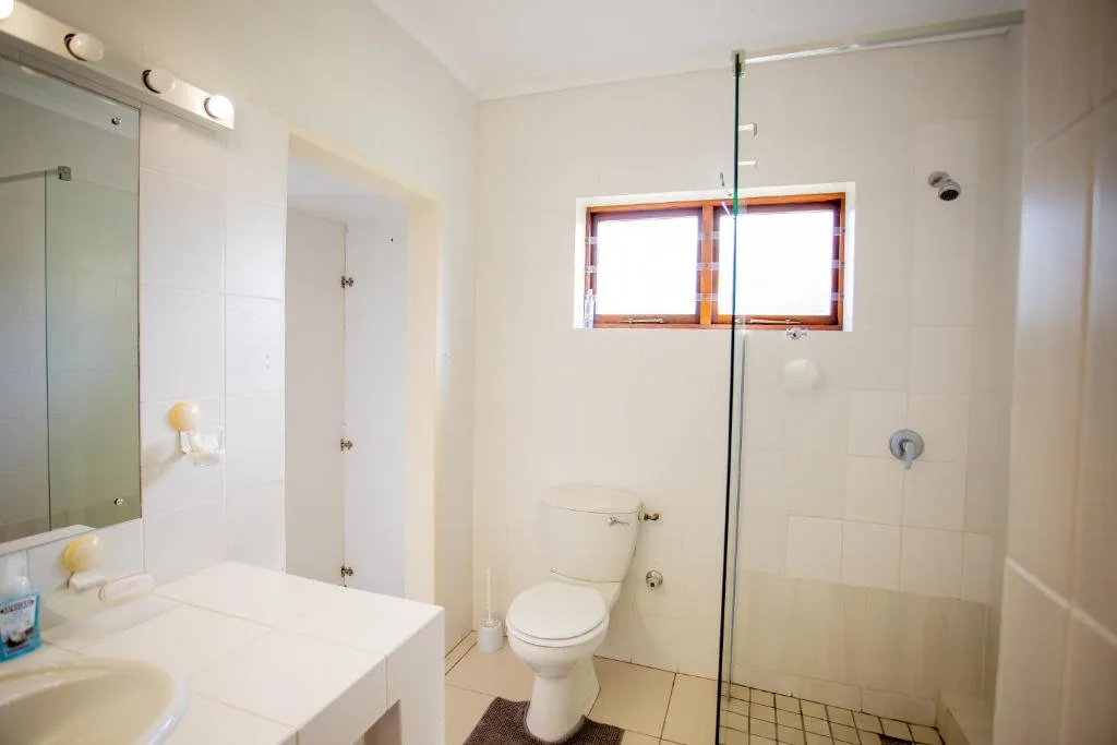 Modern bathroom with vanity, toilet, and glass-enclosed shower area