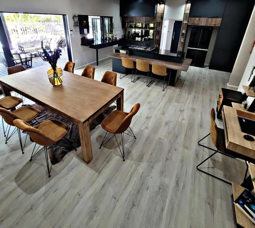 Modern dining room with wooden table and tan leather chairs