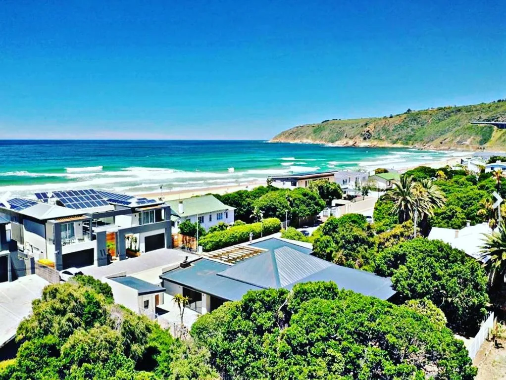 Beachfront property overlooking turquoise ocean and sandy coastline