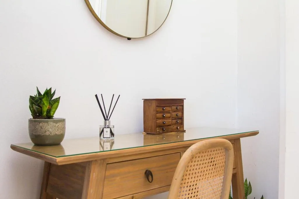 Wooden desk with succulent plant, reed diffuser, and decorative storage box