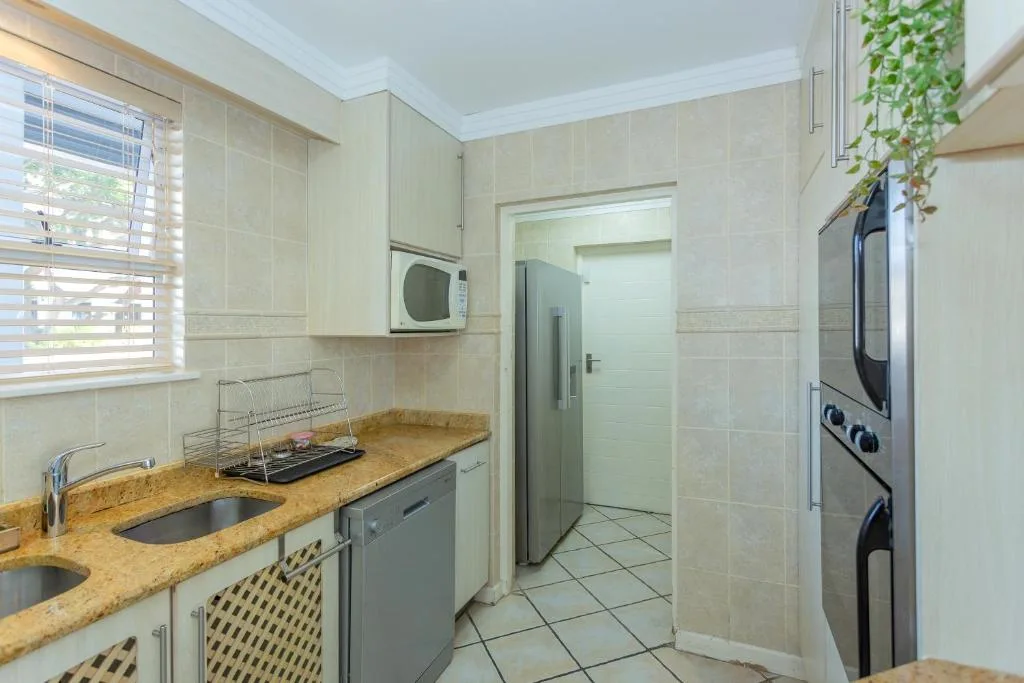 Modern kitchen with granite counters, stainless appliances, and natural light