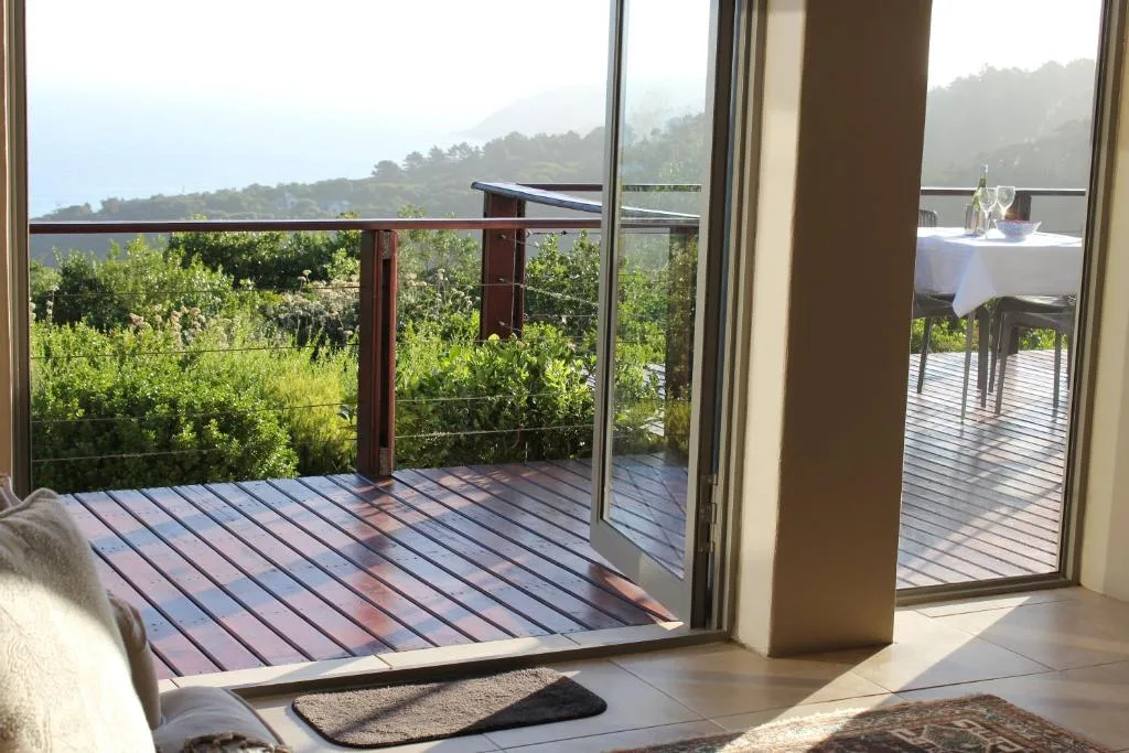 Wooden deck with mountain views, outdoor dining table setup